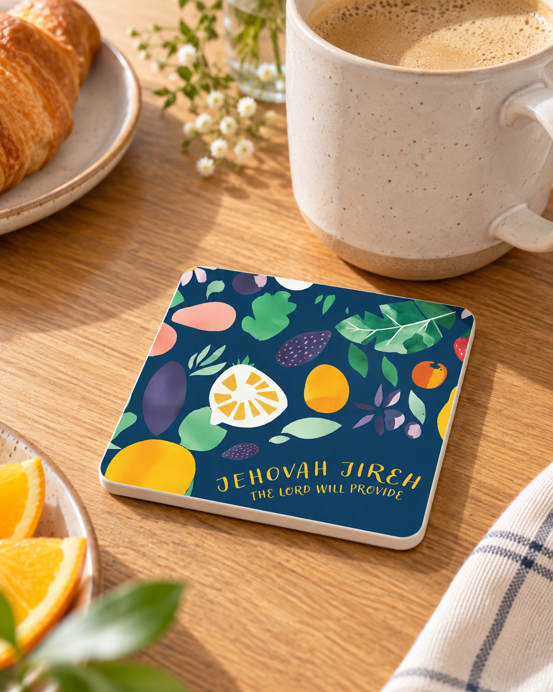 Jehovah Jireh Christian coaster with white sides styled beside coffee and breakfast in warm natural light