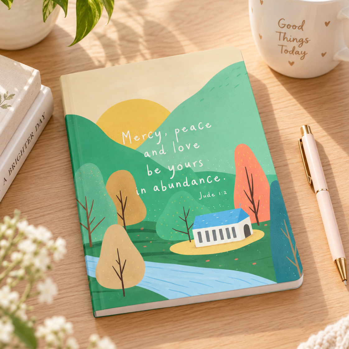 Mercy Peace and Love Jude 1:2 A5 Christian notebook styled on a warm wooden desk with coffee and stationery