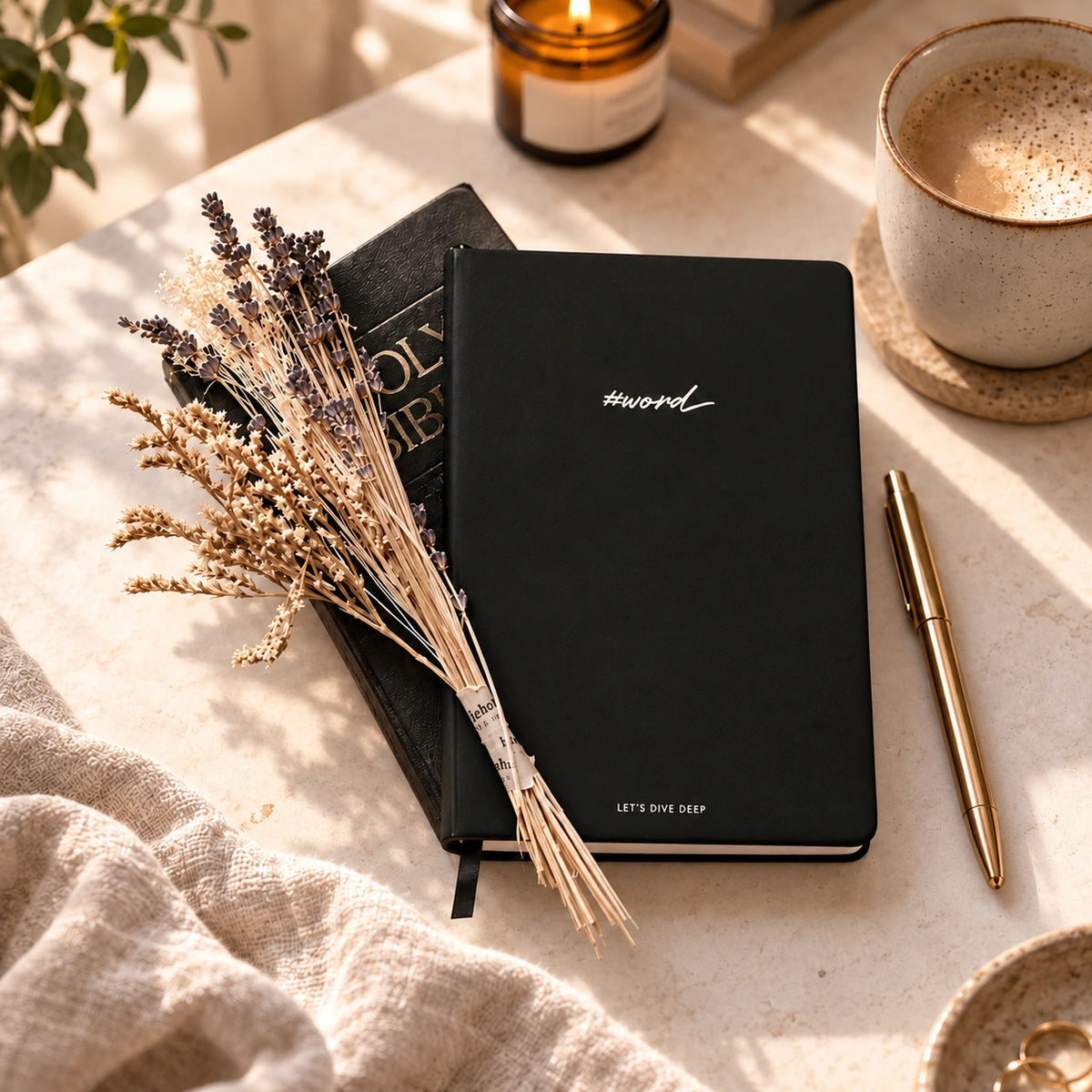 Black #Word 2.0 Bible study journal with dried lavender, Bible and gold pen on a warm sunlit desk
