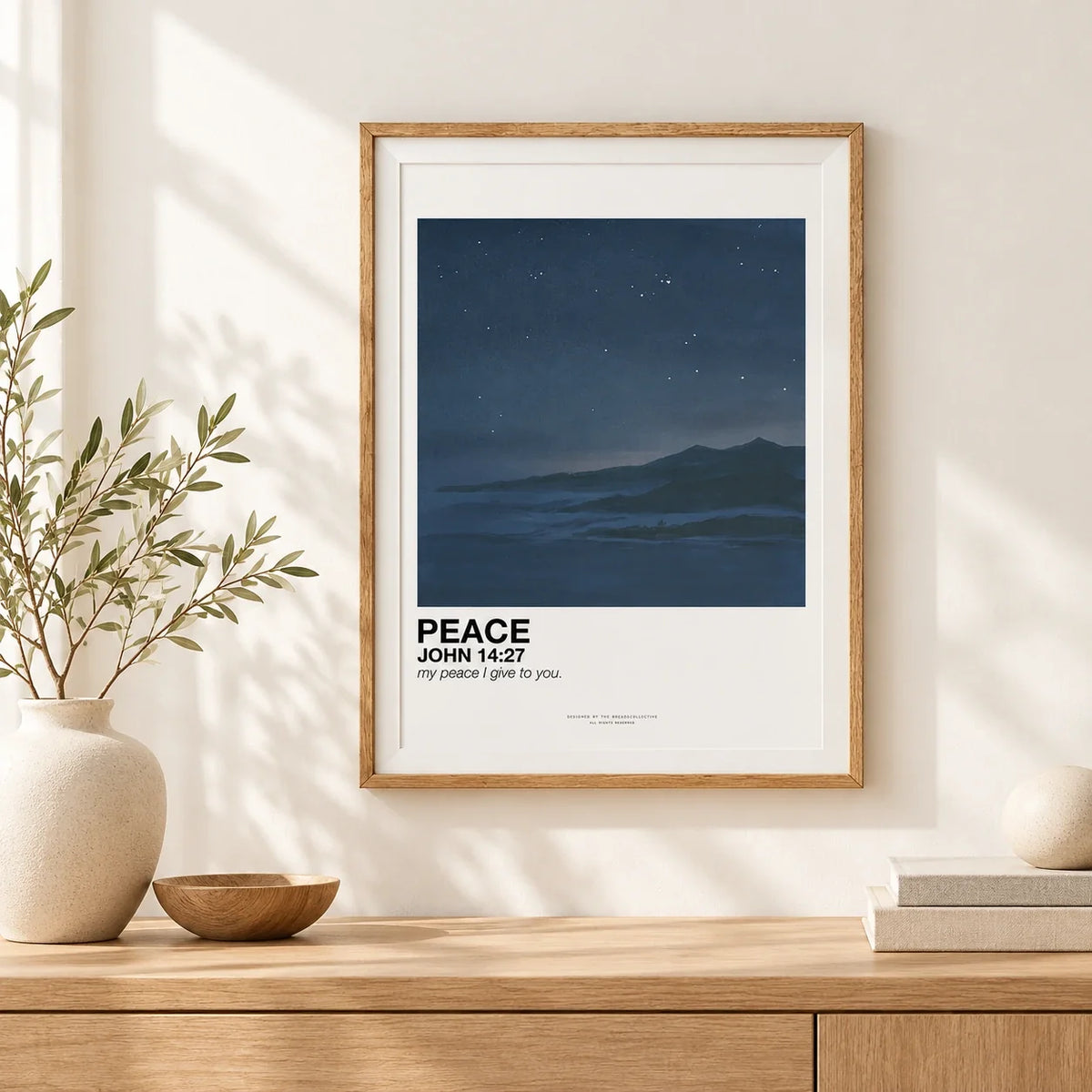 Peace John 14:27 dark blue mountain landscape poster framed in natural wood above a Japandi console