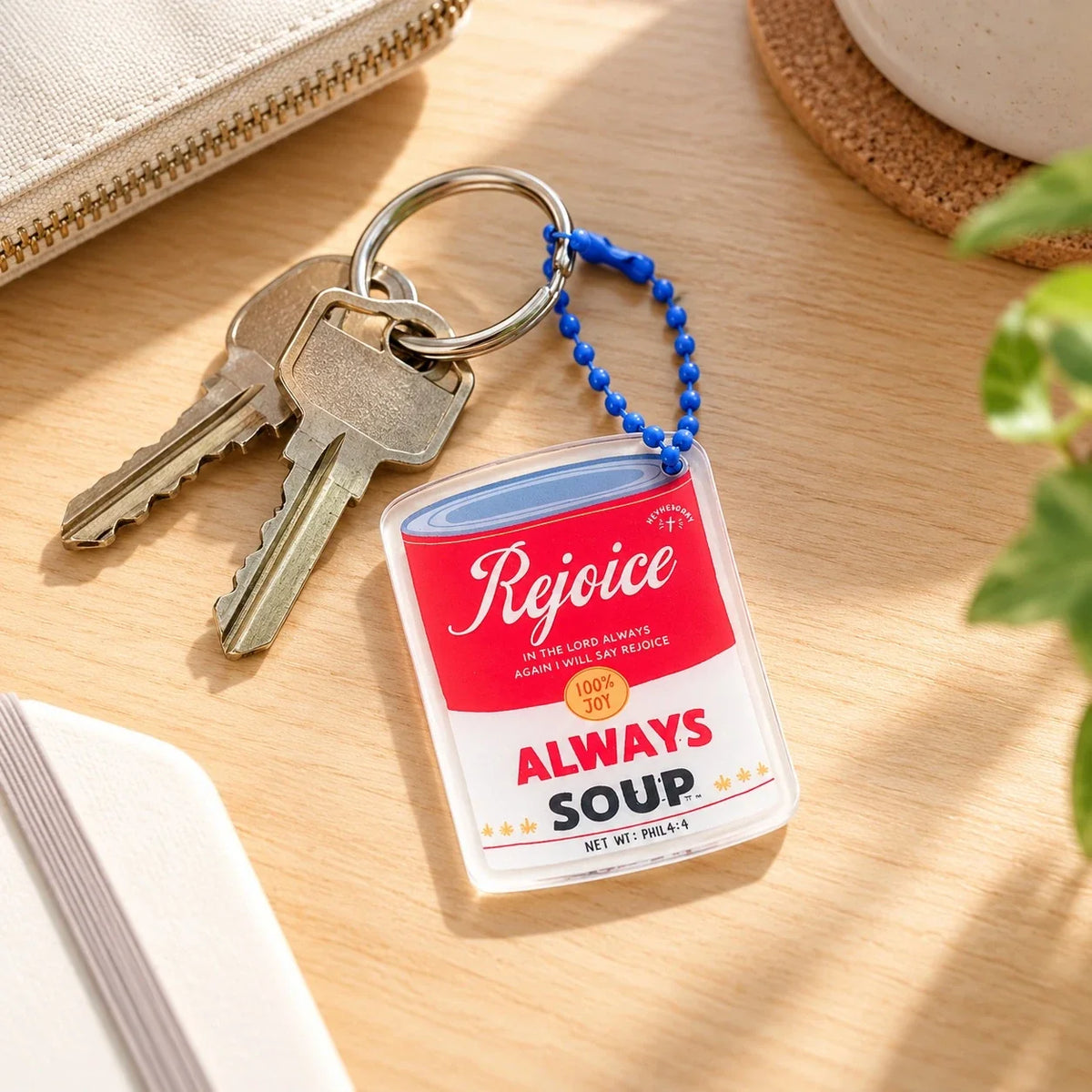 Rejoice Always soup acrylic keychain by keys on a desk