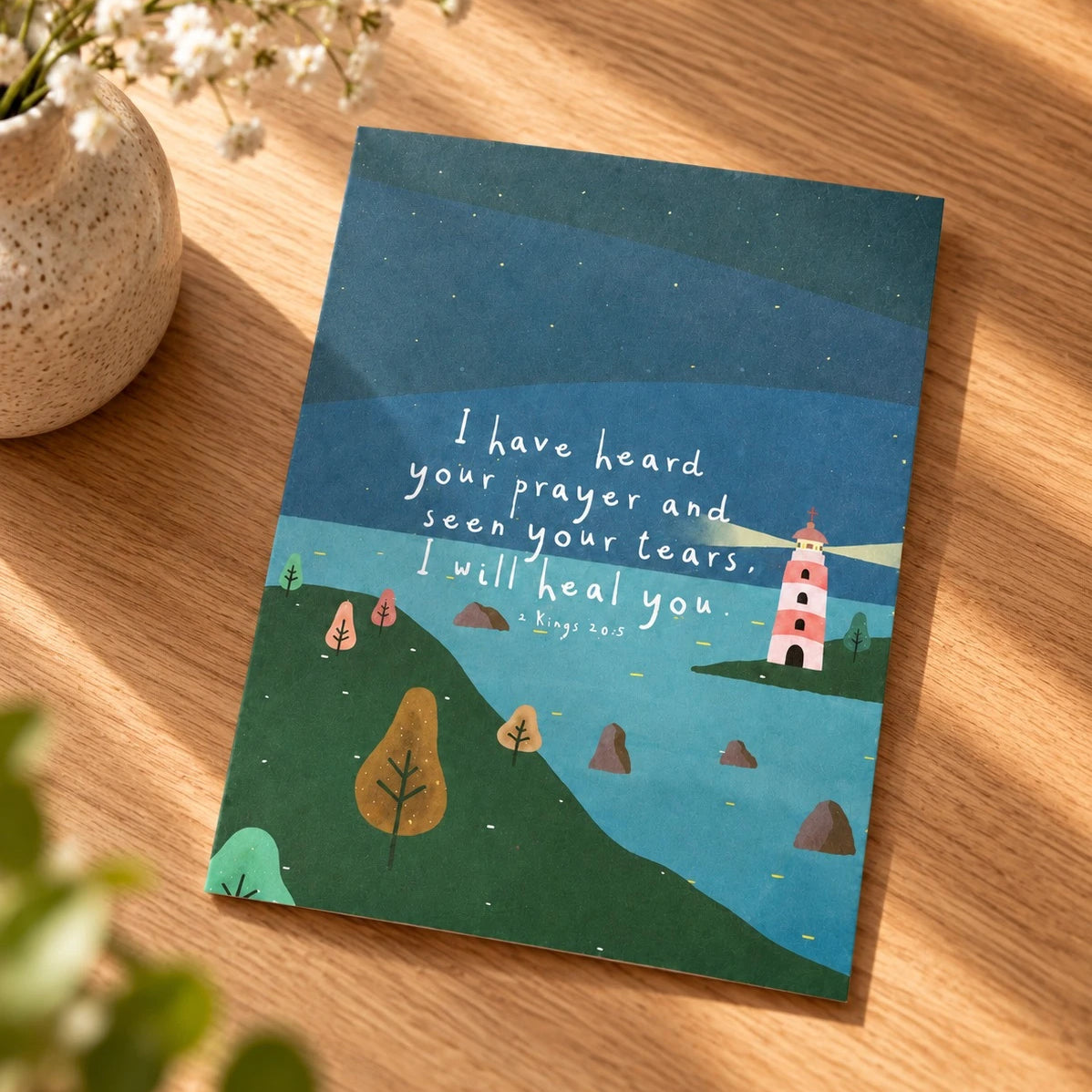 I Have Heard Your Prayer 2 Kings 20:5 card with lighthouse illustration laid on a wooden table