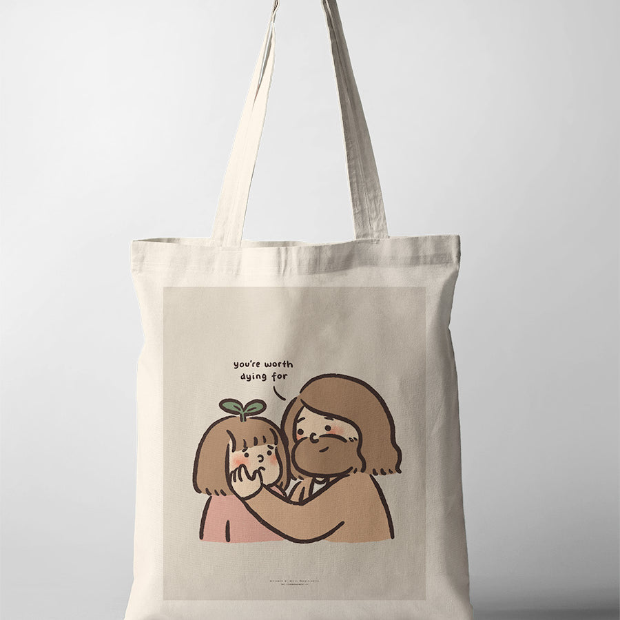 Canvas tote bag featuring a touching illustration of Jesus gently holding a child's face with the words 'You're worth dying for,' expressing deep love and value.