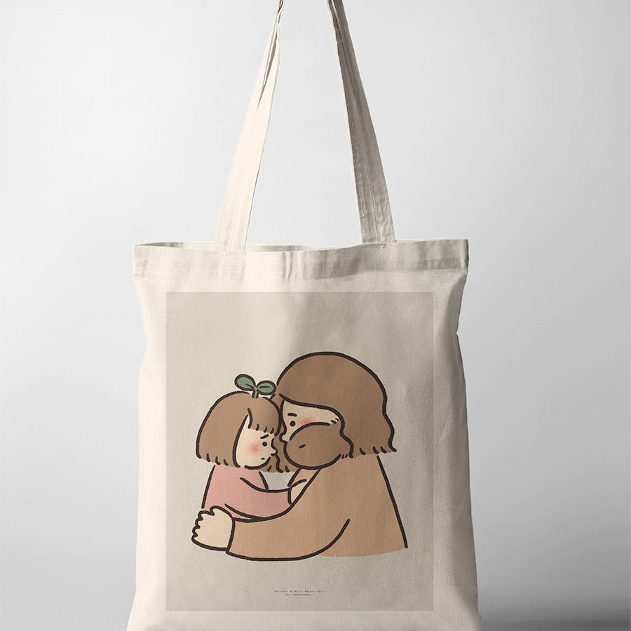 Canvas tote bag with a heartfelt illustration of Jesus sharing a tender forehead touch with a child, symbolizing comfort and love.