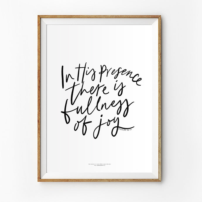 A framed poster with a handwritten-style quote reading 'In His presence there is fullness of joy' from Psalm 16:11, in black ink on a white background.