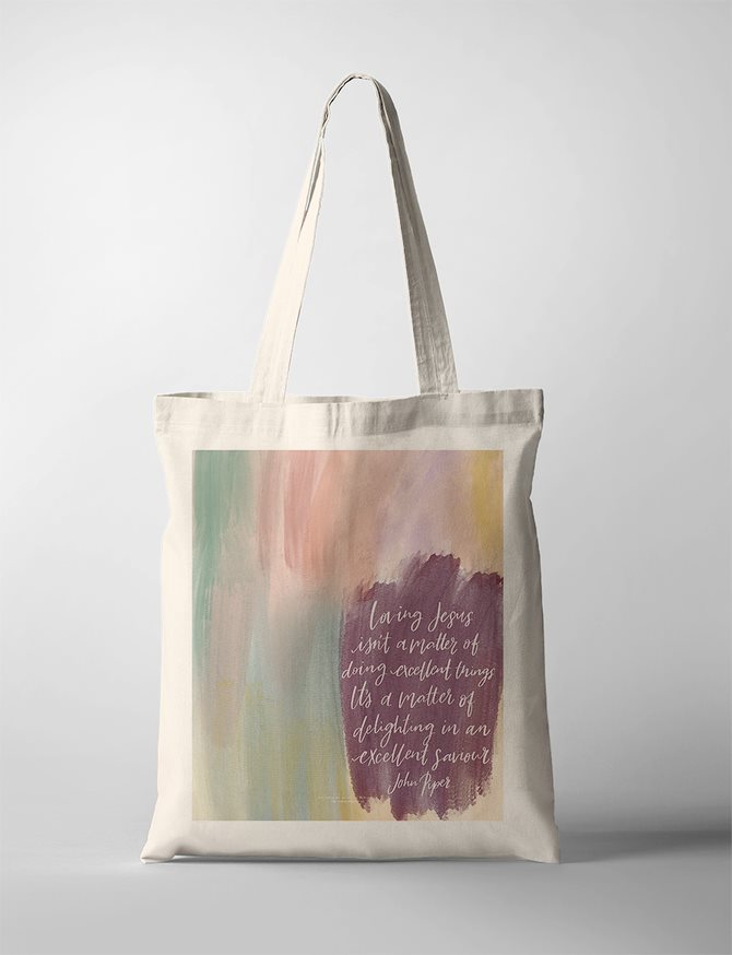 Christian faith Tote Bag with abstract pastel brush strokes and John Piper quote: 'Loving Jesus isn’t a matter of doing excellent things. It’s a matter of delighting in an excellent Saviour.' Inspirational bag as a gifts.