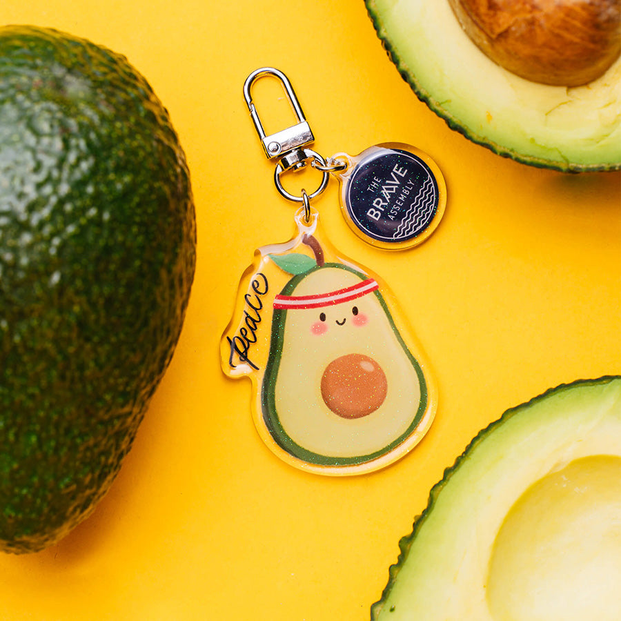 Peace Avocado v2 acrylic keychain with glitter-epoxy finish, alternate view.