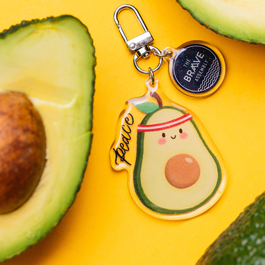 Philippians 4:7 Peace Avocado acrylic keychain with playful fruit design.