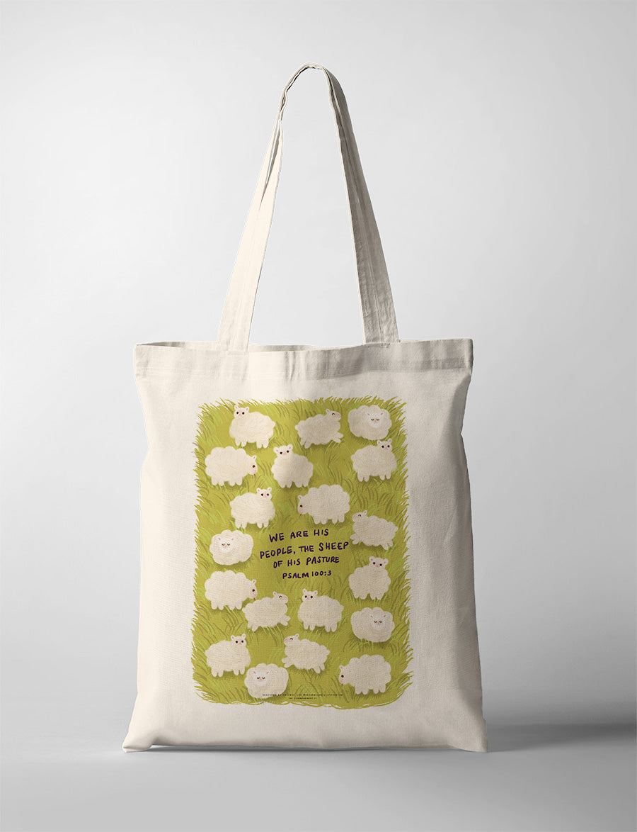 Stylish canvas tote bag with a vibrant design featuring an inspirational message, resembling a faith-based poster. The bag showcases many sheeps on a green pasture, evoking a sense of positivity and spiritual encouragement. Ideal for carrying personal items while expressing faith through a visually appealing accessory