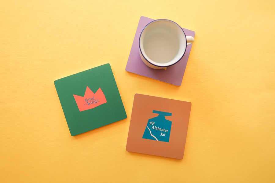 Sacred Symbol Coaster Set: Wooden square coasters featuring vibrant Christian patterns.