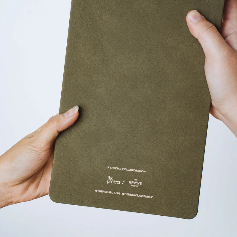 Back view of The Project J Christian notepad in Field of Grace colour, highlighting the elegant olive green cover and special collaboration details, perfect for faith-inspired daily planning.