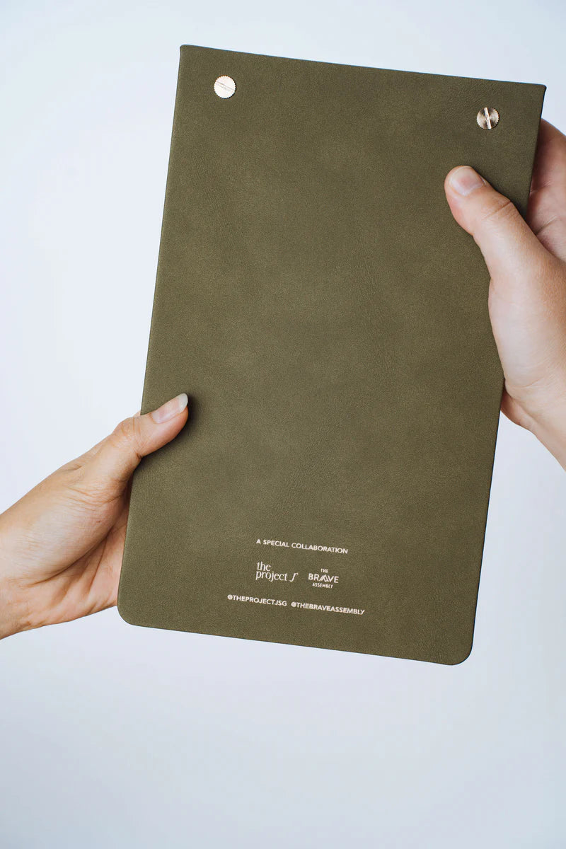 Back view of The Project J Christian notepad in Field of Grace colour, highlighting the elegant olive green cover and special collaboration details, perfect for faith-inspired daily planning.