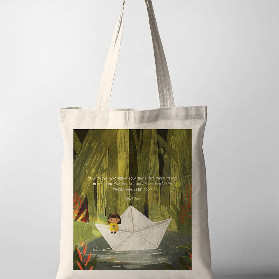 Beige tote bag featuring a whimsical illustration of a child in a paper boat surrounded by nature, accompanied by the Bible verse Psalm 9:10: 'And those who know Your name put their trust in You, for You, O Lord, have not forsaken those who seek You.' The design evokes themes of trust and faith in God's protection.