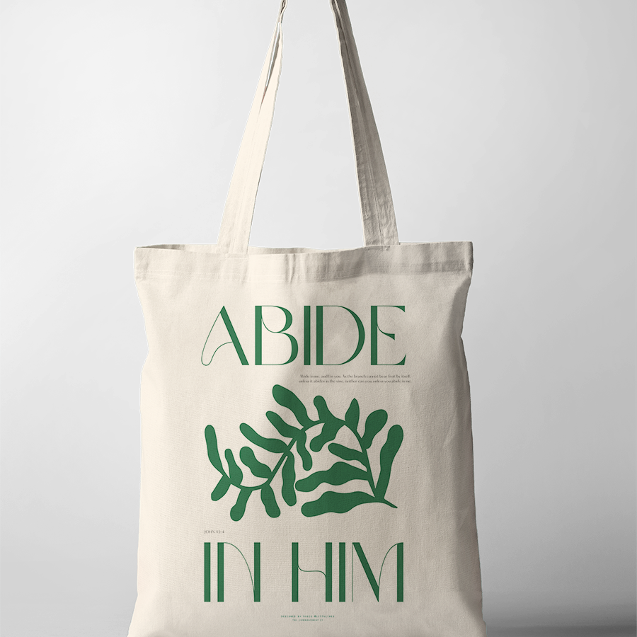 Neutral canvas tote bag featuring green botanical artwork and the uplifting Christian message "Abide in Him" by Littulines, reflecting simple happiness and faith-inspired living.