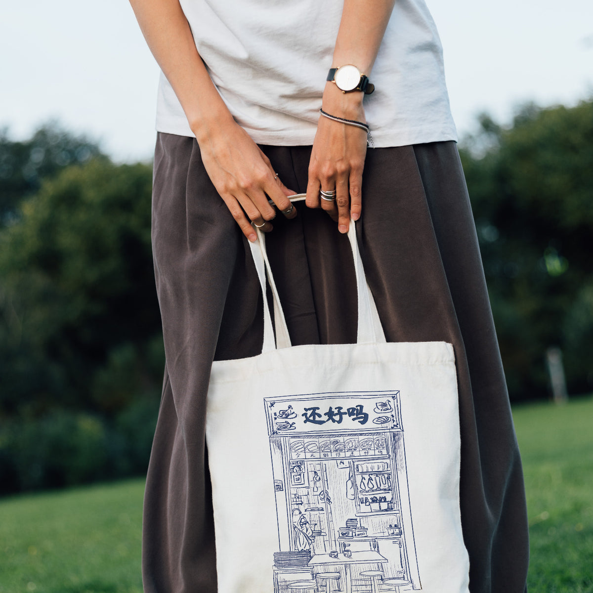 Person carrying the Are You Okay Food Stall kopitiam tote bag outdoors