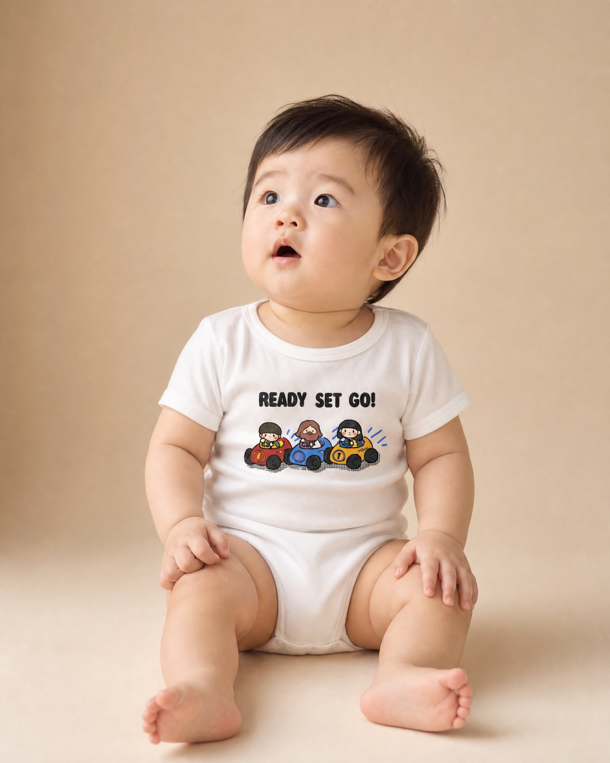 Smiling baby wearing a white Ready Set Go Christian romper with Jesus and children in race cars