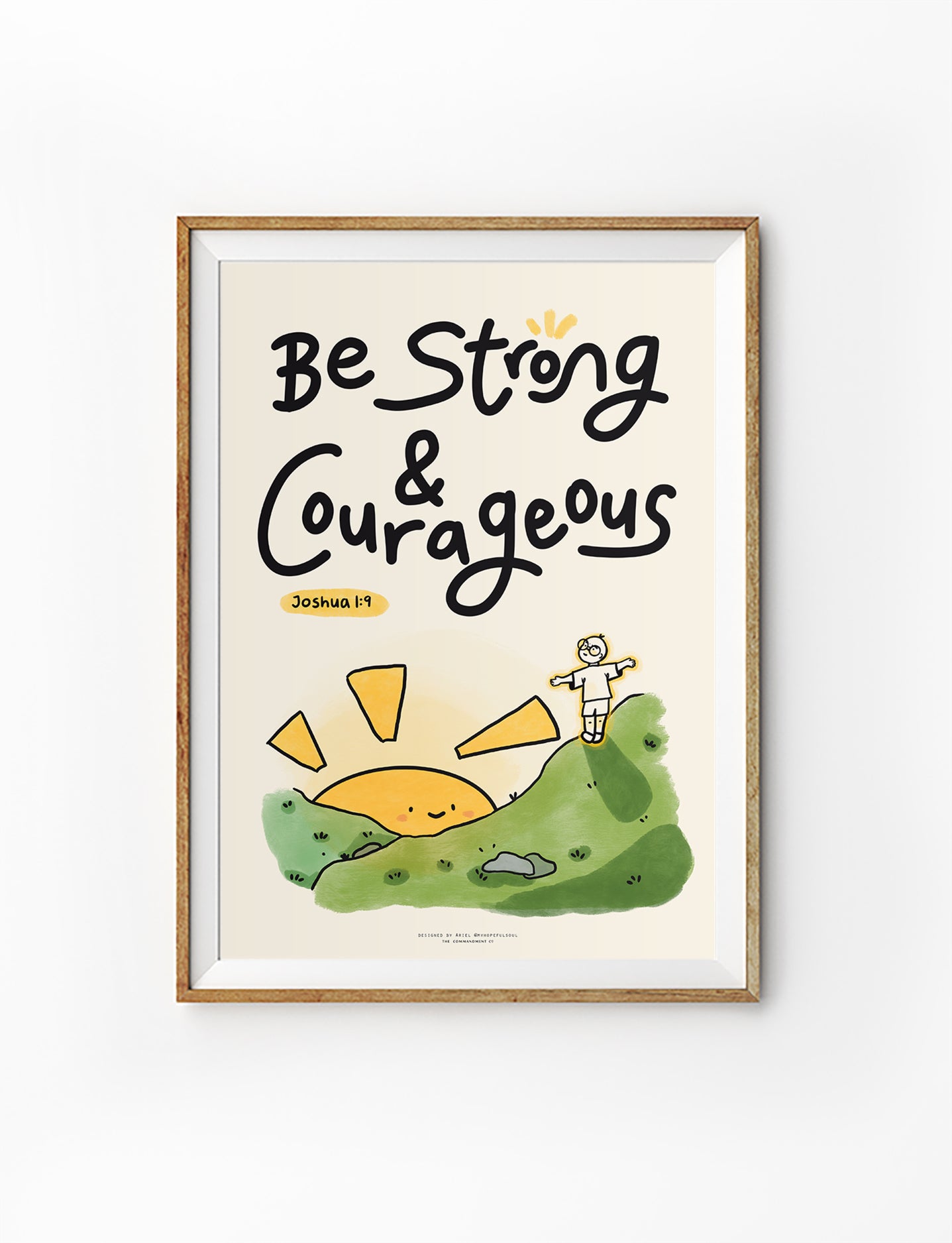Christian wall art poster featuring the phrase “Be Strong & Courageous” from Joshua 1:9 with cute illustrated hill and sunrise, in collaboration with @myhopefulsoul.