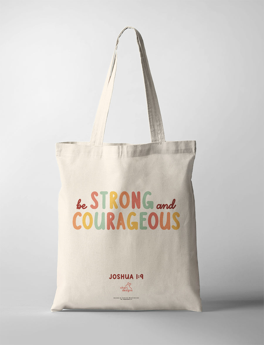 Christian canvas tote bag featuring “Be Strong and Courageous” Joshua 1:9 in colourful typography, faith-inspired tote bag collaboration with Chari Designs.