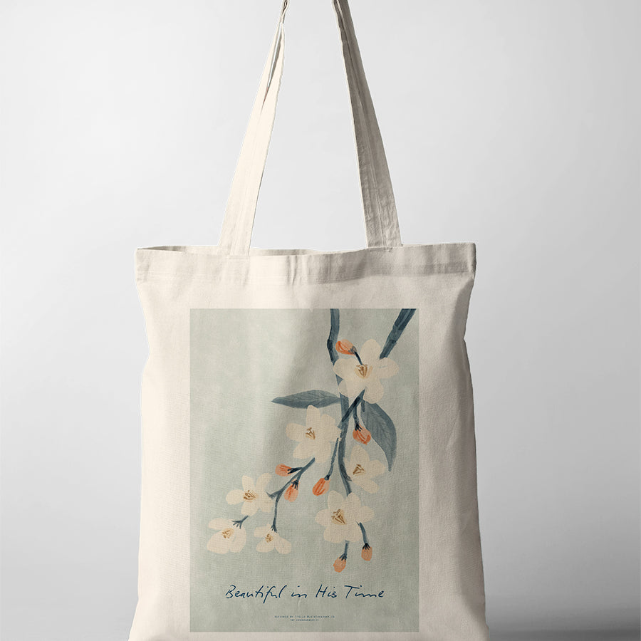 Christian canvas tote bag featuring floral artwork and the phrase “Beautiful in His Time,” faith-inspired design collaboration with letstakeanap_id.