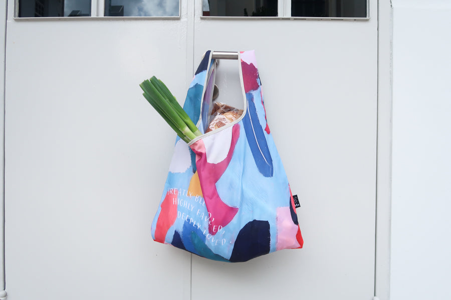 Bible verse shopping bag
with with phrase “Greatly
blessed, Highly Favored,
Deeply Loved” in abstract
colorful design, ideal for
Christian gifts and daily
use from a Christian gift
store.