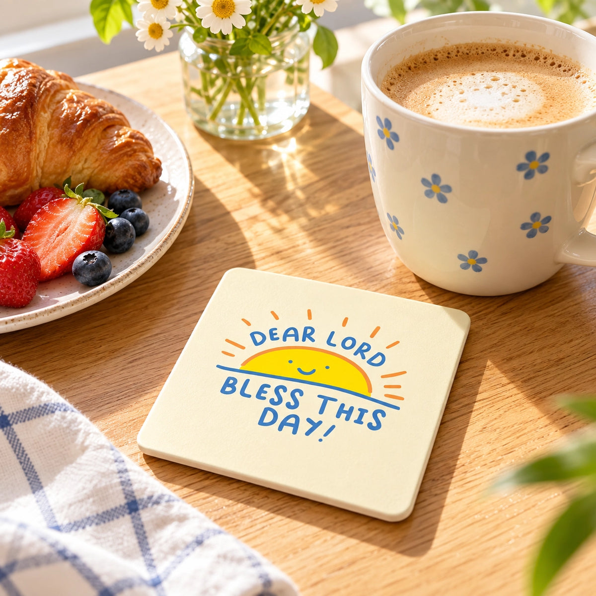 Bless This Day Christian coaster styled on a sunlit breakfast table beside coffee and pastries.