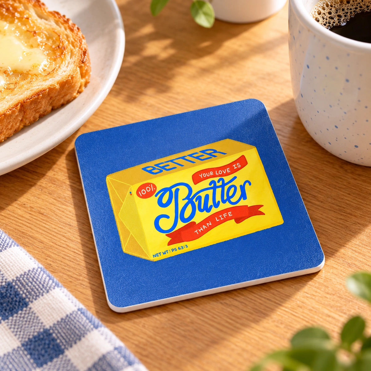 Butter Than Life LOVE SUPERMARKET Christian coaster styled beside coffee and toast.