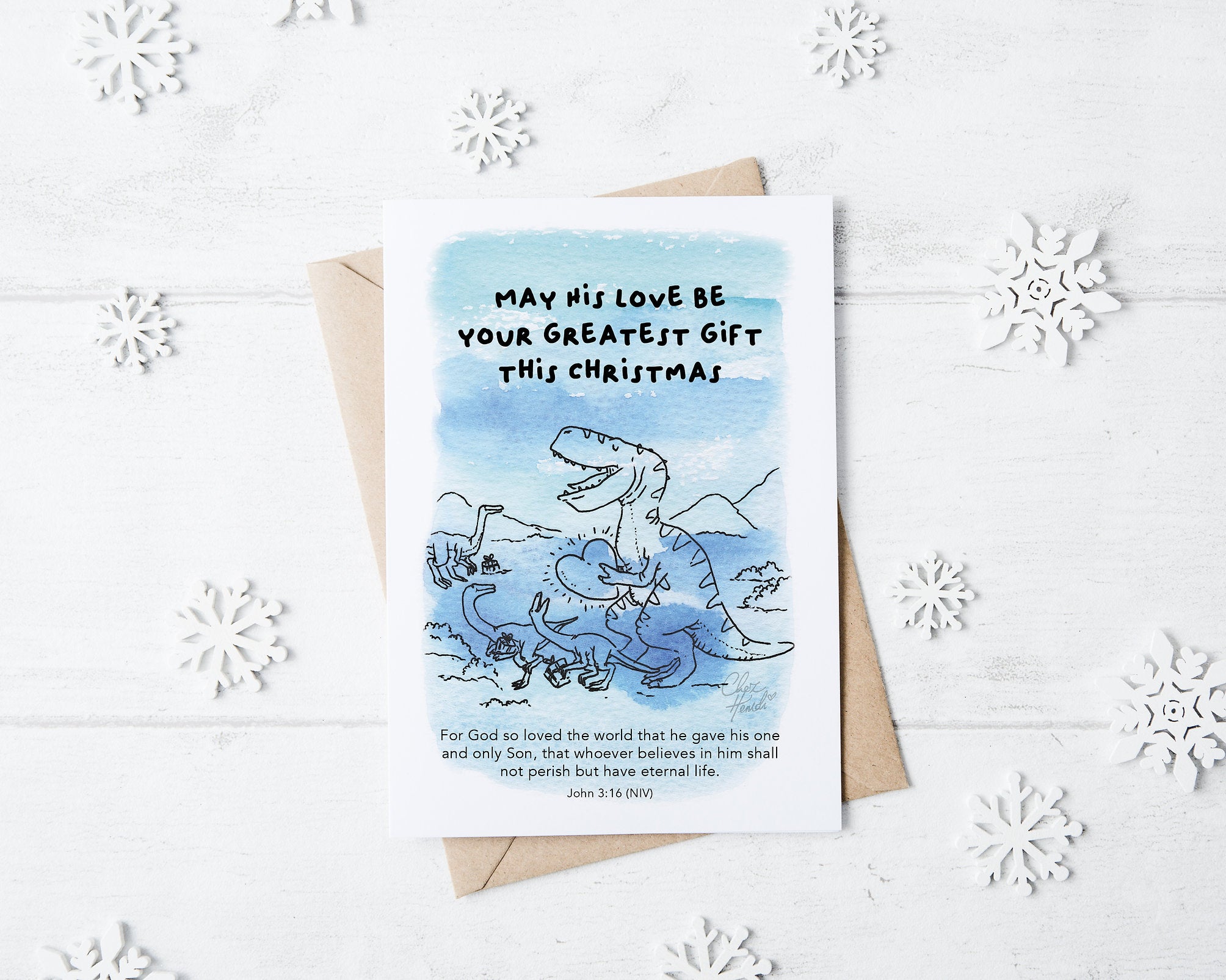 ChezHemdi A6 dino postcard with ‘May His Love Be Your Greatest Gift This Christmas’ verse – Christian Christmas card from The Commandment Co