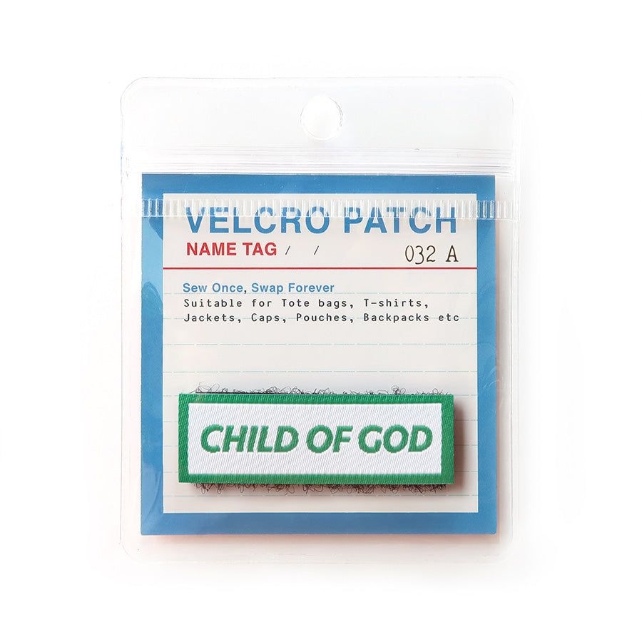 Velcro tag with the phrase 'Child of God' in green text on a white background with a green border; a Christian identity accessory for clothing and bags.