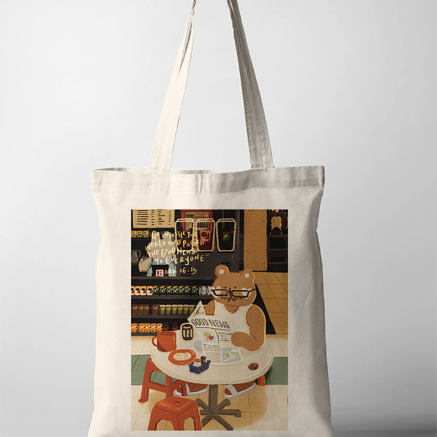 Natural canvas Christian tote bag featuring a bear reading the Good News in a convenience store with Mark 16:15.