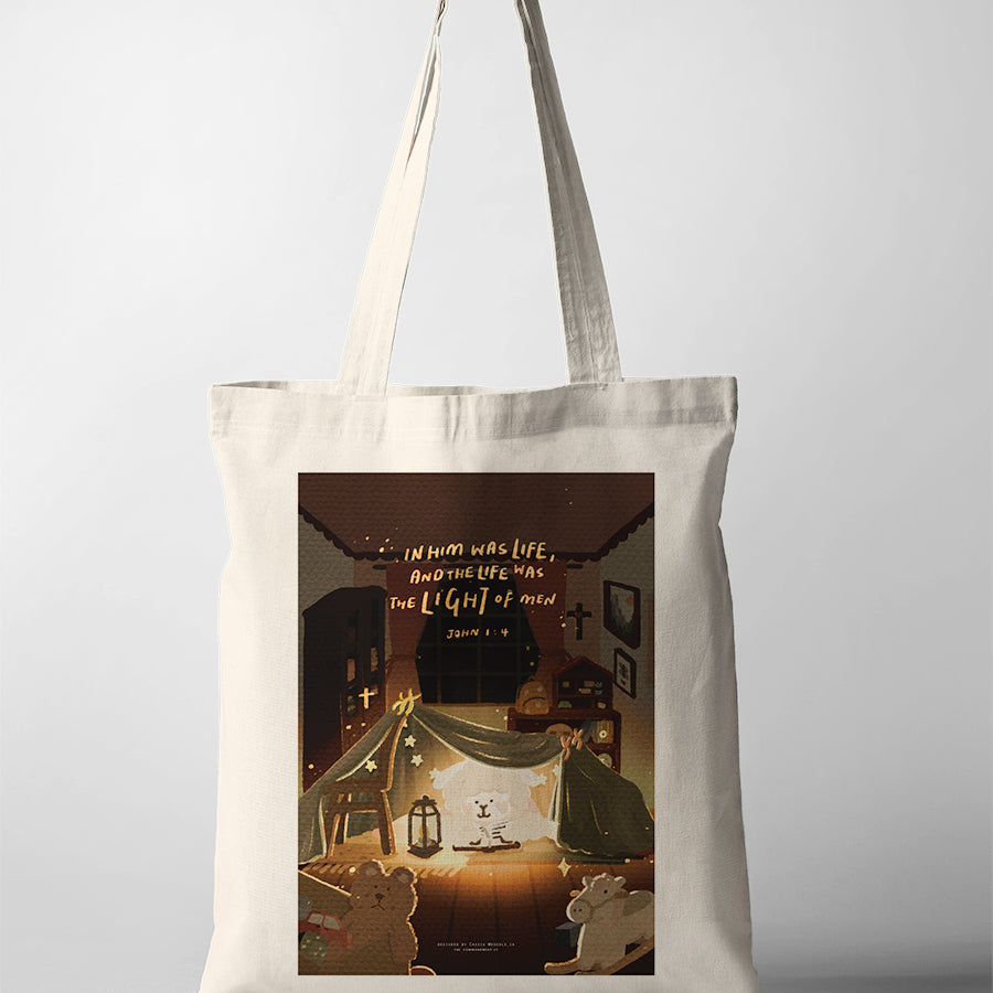 Natural canvas Christian tote bag featuring a cosy night-time blanket fort illustration and John 1:4 about the light of men.