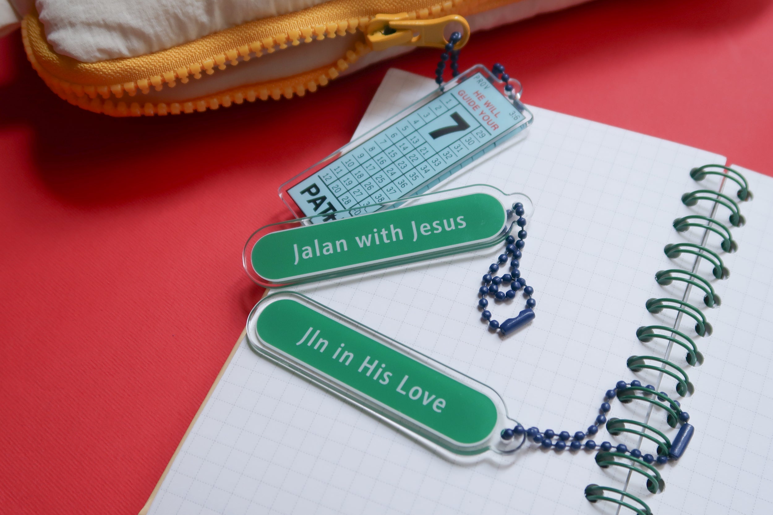 Christian Jalan with Jesus keychain and Join in His Love keychain on notebook – uplifting faith gifts by The Commandment Co