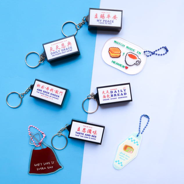 Christian lightbox keychain collection glowing in a dark display