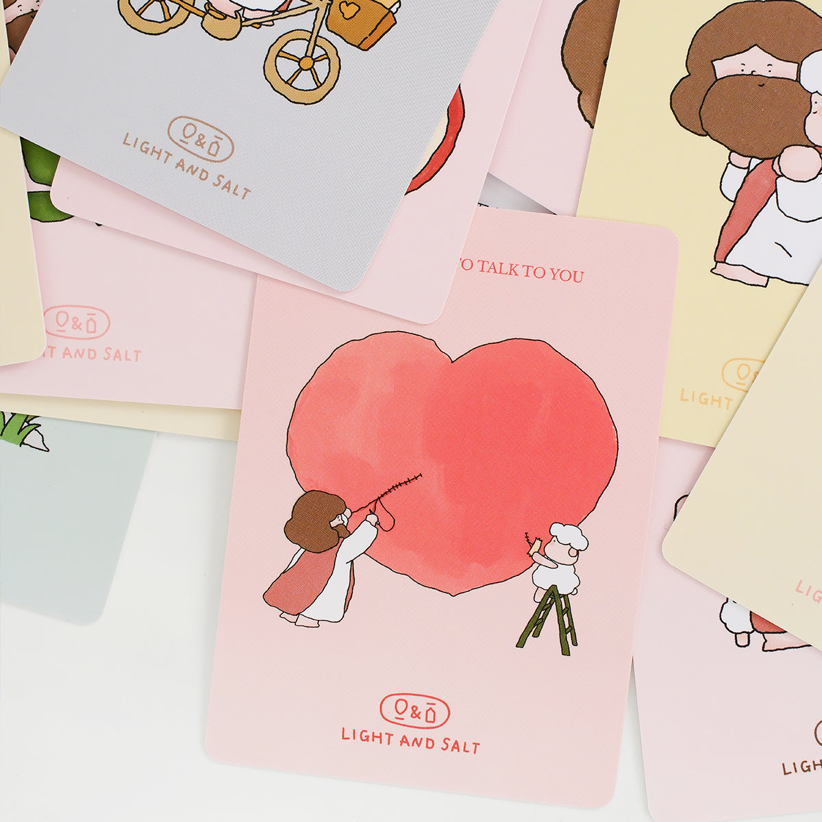 Close-up of a Christian mini card with a heart illustration and cute Jesus design, part of an encouragement card set
