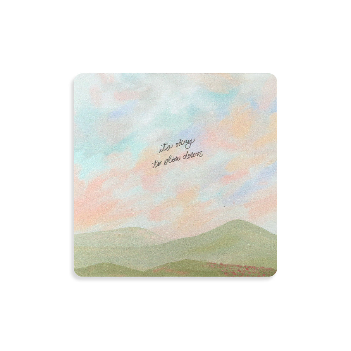 Christian motivational coaster with a serene pastel landscape and the message 'It's okay to slow down,' perfect for inspirational home decor.