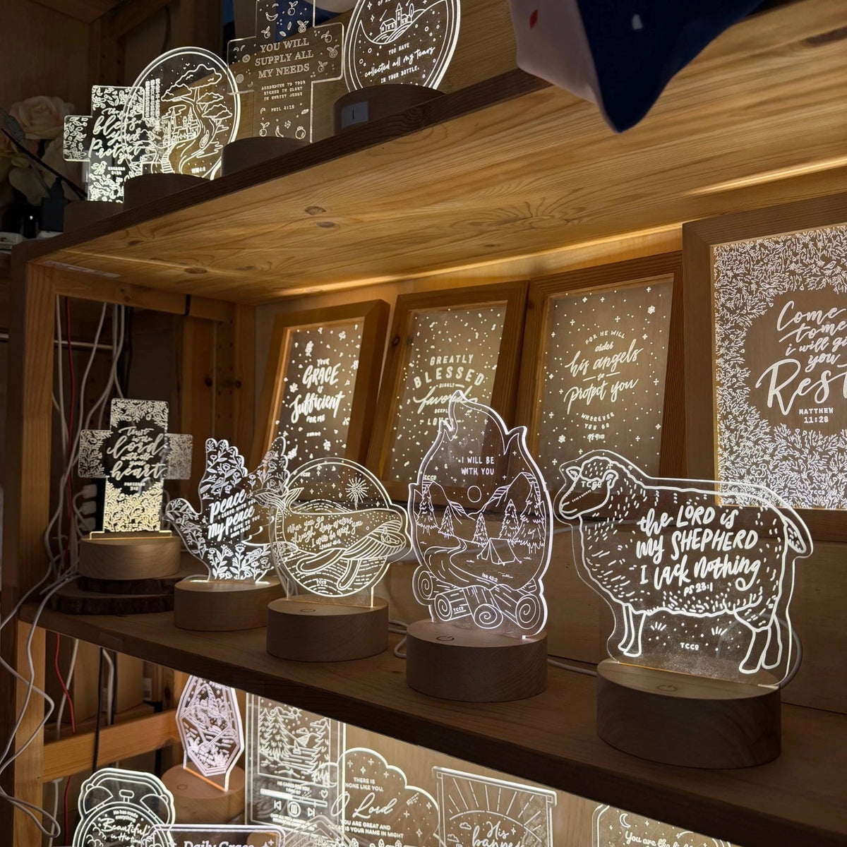 The Commandment Co Christian night lights displayed together on wooden shelves
