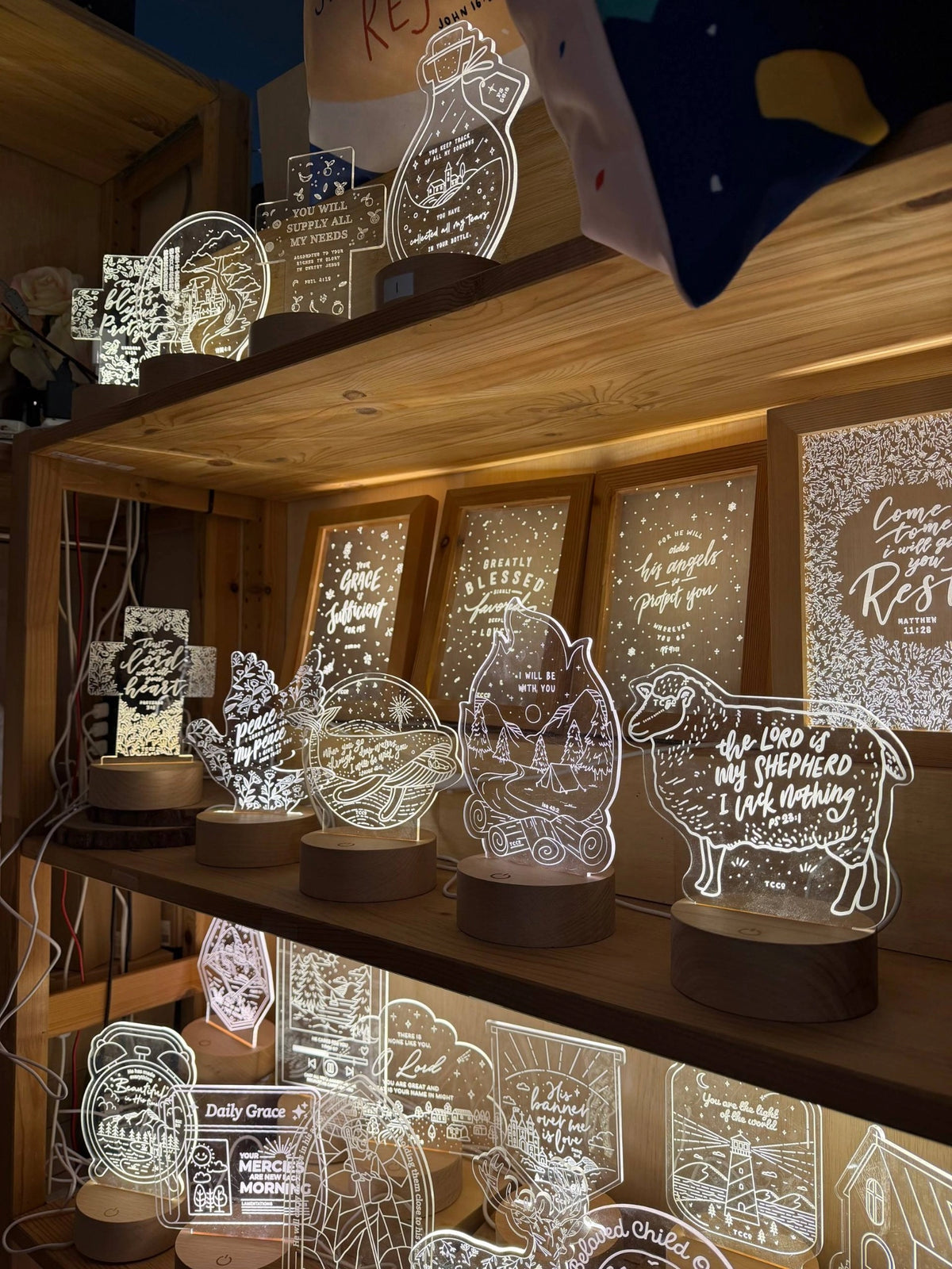The Commandment Co Christian night lights displayed together on wooden shelves