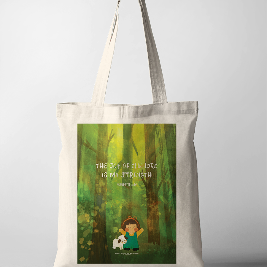Christian tote bag featuring a joyful girl with a sheep in a lush green forest, printed with the uplifting Bible verse "The joy of the Lord is my strength" from Nehemiah 8:10, inspiring simple happiness and faith.