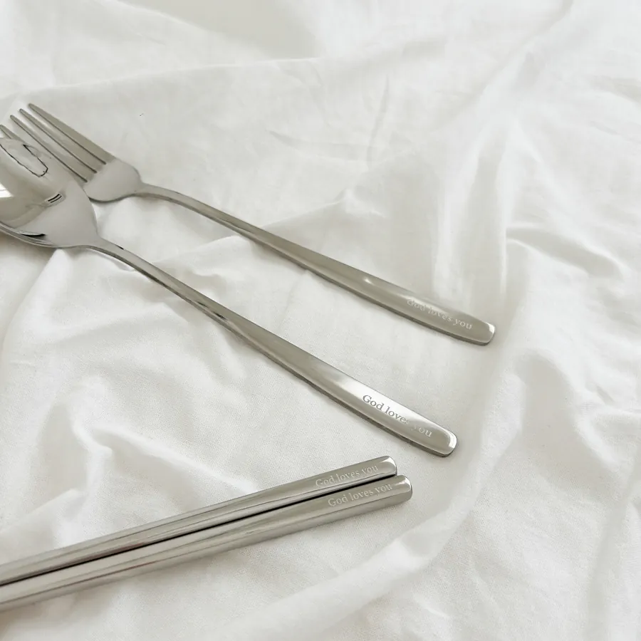 Stainless steel cutlery set including a spoon, fork, and chopsticks in a canvas pouch with the message "God loves you" and a Bible verse from Jeremiah 31:3.