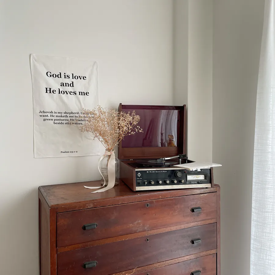 Front of wall tapestry with “God is love and He loves you” text in soft cotton-linen fabric