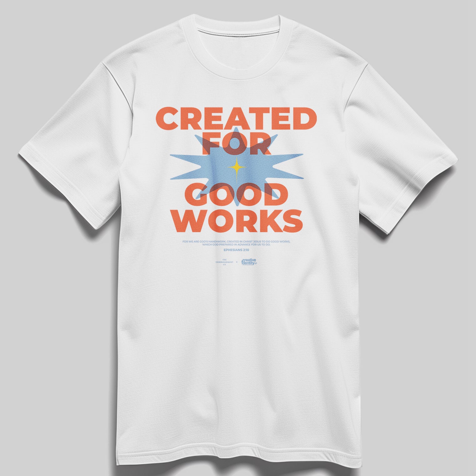 White Christian t-shirt featuring bold orange and blue “Created for Good Works” design, created by The Commandment Co in collaboration with YWAM.