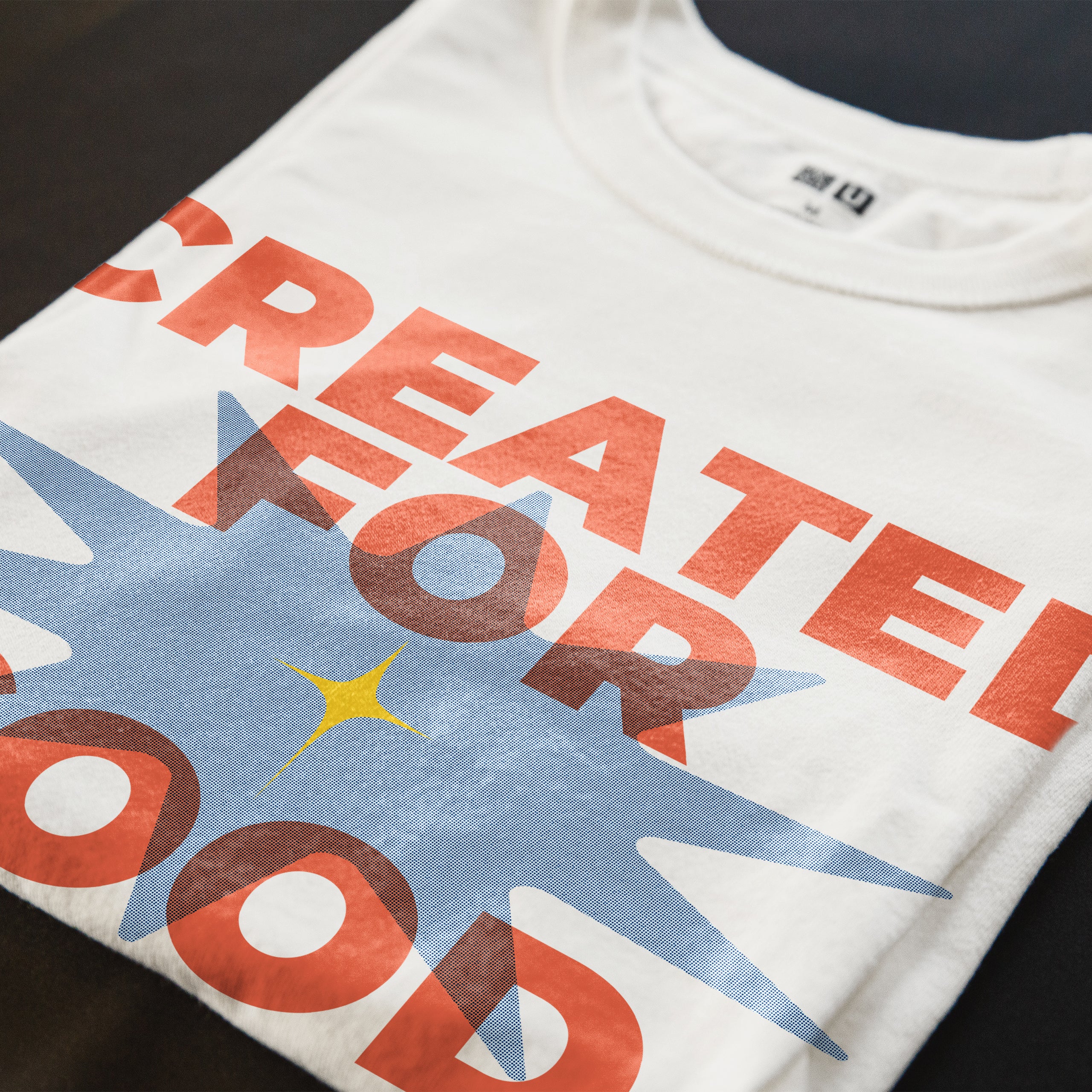 Close-up of the “Created for Good Works” Christian t-shirt print with orange typography, blue graphic detail, and Ephesians 2:10 verse reference.