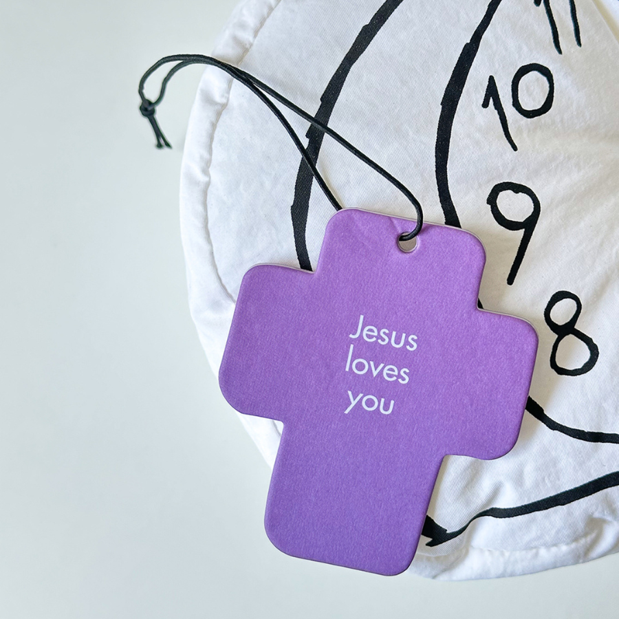 Purple cross-shaped heart scent tag with the uplifting message "Jesus loves you," perfect for sharing encouragement and simple happiness in daily life.