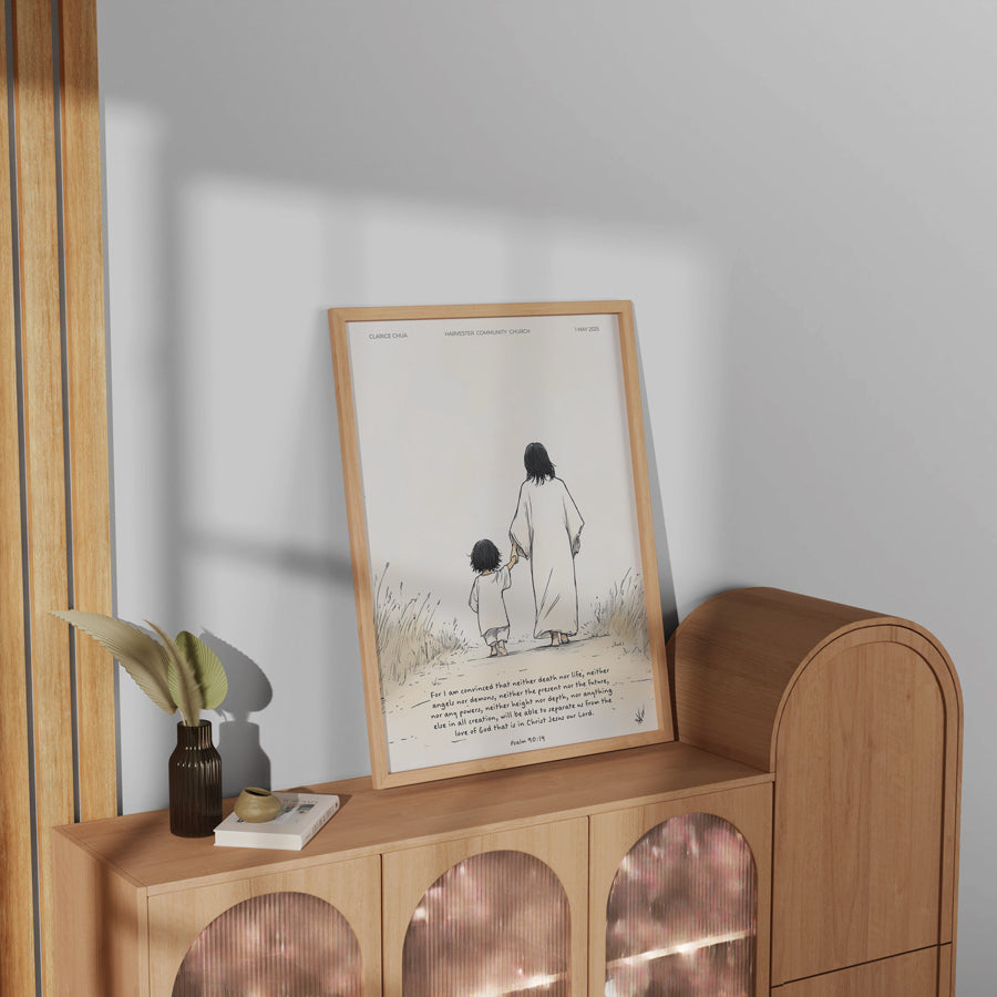 Customisable baptism poster featuring Jesus holding a child's hand, displayed on a wooden cabinet, a meaningful baptism gift from The Commandment Co, Singapore's Christian gifts store.