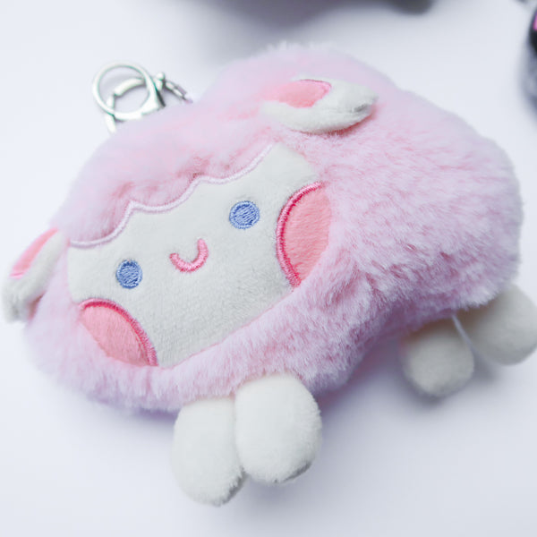 Three faith-inspired Lil Sheepies plush keychains in White Cumulus, Pink Hana, and Stormy Gray are displayed on a white background. Each soft, fluffy sheep represents a reminder of the Good Shepherd’s love, featuring a Bible verse charm, a retractable string for easy card access, and a secure keychain clip. Perfect as a Christian gift or daily faith companion.