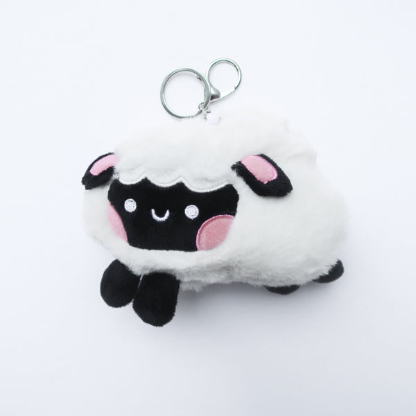 Three faith-inspired Lil Sheepies plush keychains in White Cumulus, Pink Hana, and Stormy Gray are displayed on a white background. Each soft, fluffy sheep represents a reminder of the Good Shepherd’s love, featuring a Bible verse charm, a retractable string for easy card access, and a secure keychain clip. Perfect as a Christian gift or daily faith companion.