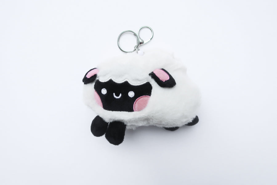 Three faith-inspired Lil Sheepies plush keychains in White Cumulus, Pink Hana, and Stormy Gray are displayed on a white background. Each soft, fluffy sheep represents a reminder of the Good Shepherd’s love, featuring a Bible verse charm, a retractable string for easy card access, and a secure keychain clip. Perfect as a Christian gift or daily faith companion.