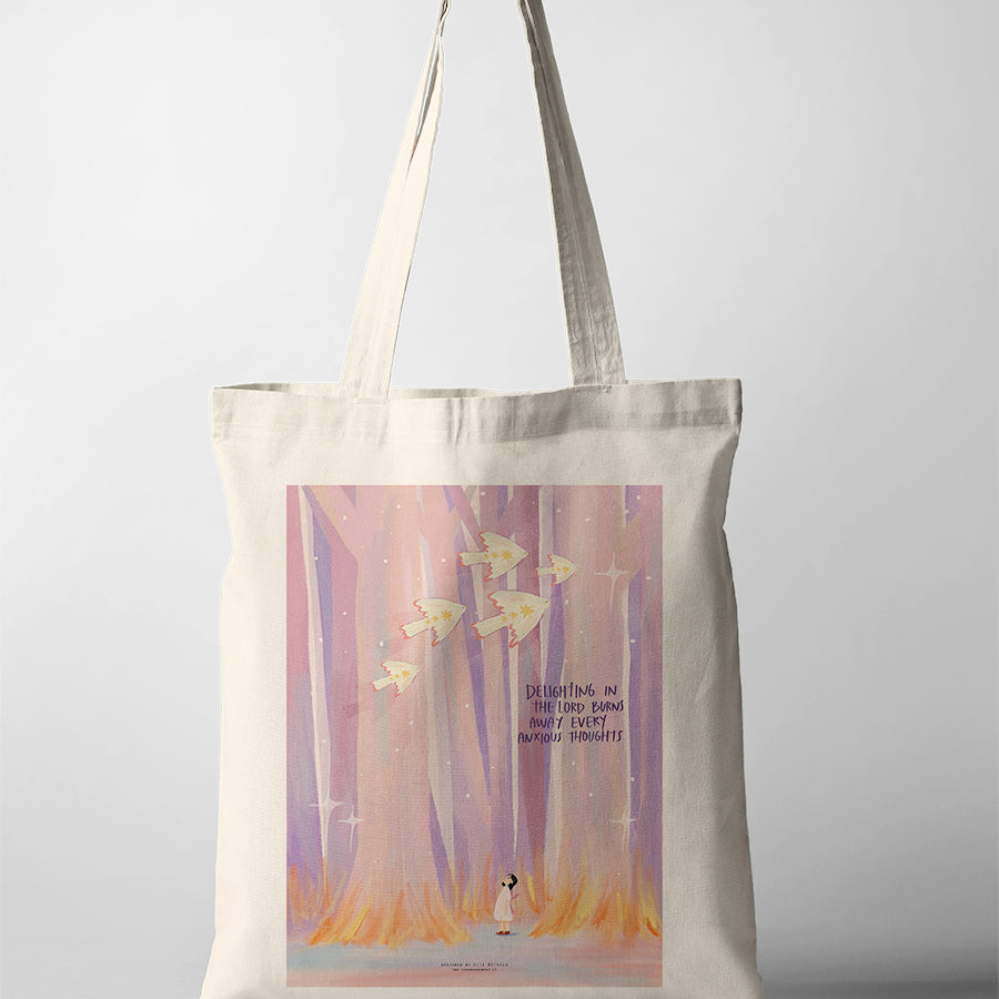 Canvas tote bag featuring Dita illustration of a girl in a dreamy pink forest with the phrase “Delighting in the Lord burns away every anxious thought”