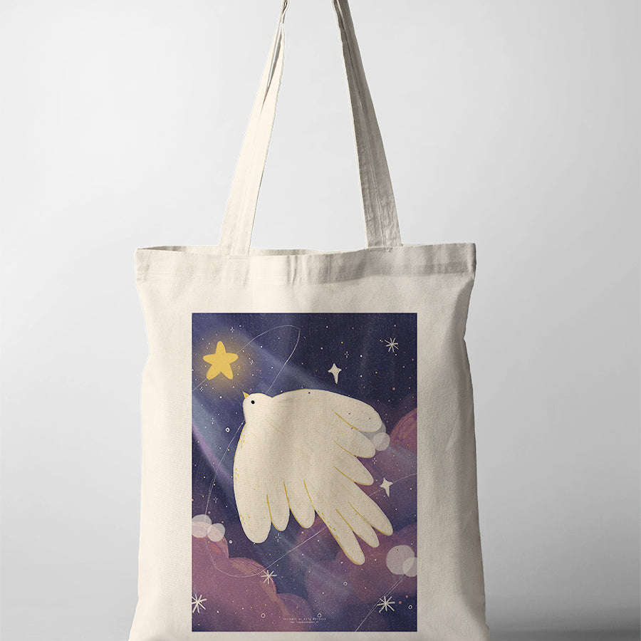 Canvas tote bag with Dita illustration of a white dove flying in a starry night sky holding a glowing star, symbol of peace and hope