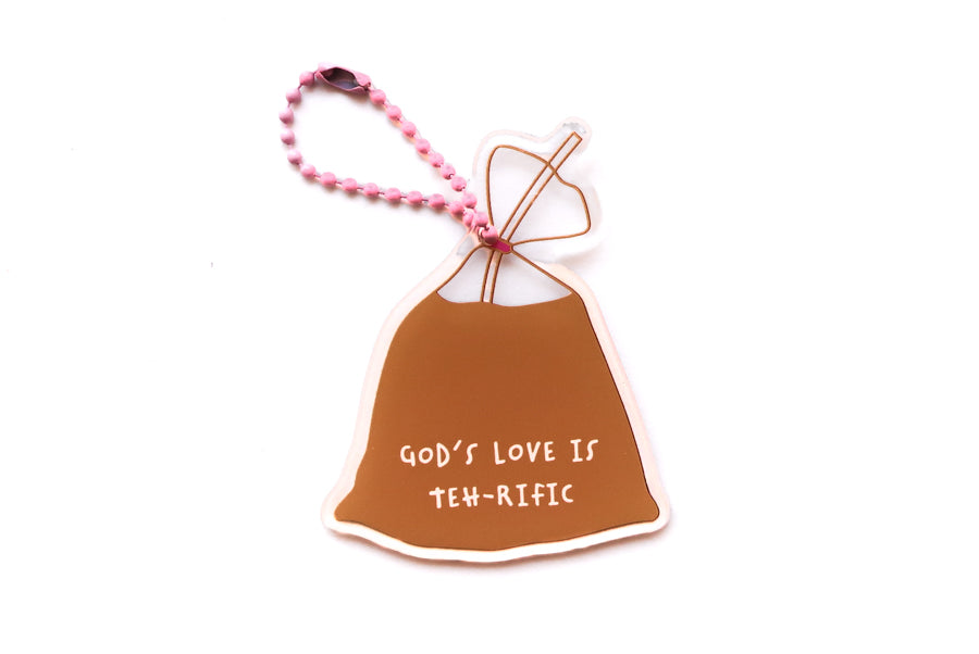 Front view of Singapore drink bag-inspired Christian acrylic keychain featuring “God’s Love Is Teh-rific” with pink ball chain