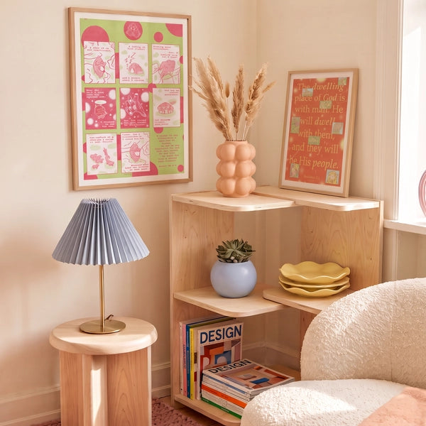 Dwelling Place of God orange Revelation 21:3 Christian poster displayed in a warm living room beside a pink and green Love Has Brought Me Back Home poster